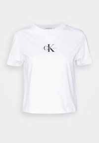 Bílá bavlněná tričko s kulatým výstřihem, krátkými rukávy a černou grafikou loga Calvin Klein na hrudi. Klasický střih.