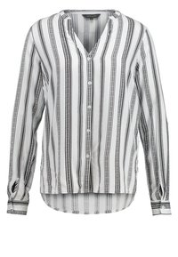 Blouse à rayures noires et blanches, tissu léger, décolleté en V, boutonnage sur le devant, manches longues avec poignets à boutons, ourlet incurvé.