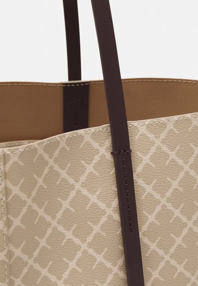 Beige leather tote bag with a textured pattern, featuring smooth brown straps and contrasting interior. Visible stitching on edges.