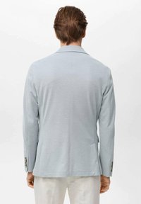 Light blue blazer made from smooth fabric, with a tailored fit, single-breasted design, and two side pockets. Button accents near cuffs.