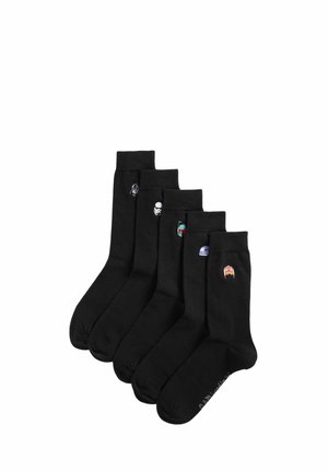 Cinque paia di calzini neri, ciascuno con un piccolo personaggio di elmo di Star Wars ricamato vicino alla caviglia.