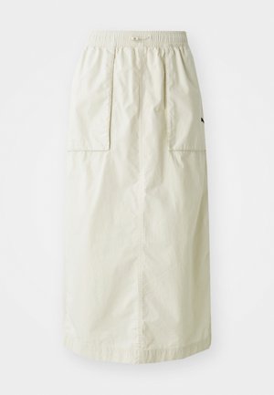 Falda de crema hasta la rodilla con cintura elástica, dos bolsillos frontales y un diseño sencillo. Fabricada con tejido ligero.