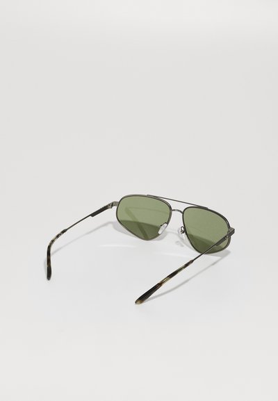 Sunglasses with green-tinted lenses and black metal frame, featuring a double bridge and tortoiseshell-patterned temple arms.
