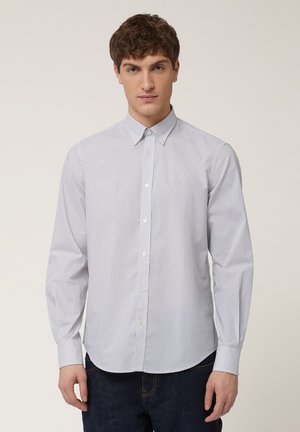 Lange mouwen shirt in lichtblauw met een subtiel geometrisch patroon. Bevat een button-down kraag en een ronde zoom. Gemaakt van lichtgewicht stof.