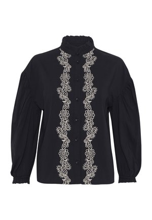 Blusa nera con colletto alto, caratterizzata da un intricato ricamo floreale bianco sulla parte anteriore e maniche a sbuffo con polsini elasticizzati.