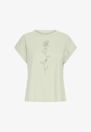 Svetlo zelena majica s kratkimi rokavi z zavihanimi rokavi in črno neprekinjeno linijsko risbo vrtnice, ki je postavljena na sredino sprednjega dela.