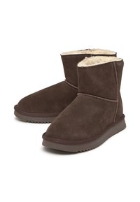 Botines de gamuza marrón con un forro interior acolchado, detalles cosidos y suela de goma texturizada para agarre y durabilidad.