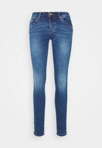 Jeans ajustados en denim azul oscuro con un efecto desgastado, diseño de cinco bolsillos y cierre de botón. Presenta un dobladillo sin rematar en los tobillos.