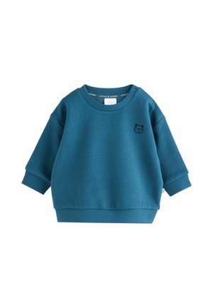 Petrolblå sweatshirt lavet af blødt stof, med rund halsudskæring, lange ærmer og et lille broderet bjørnelogo på brystet.