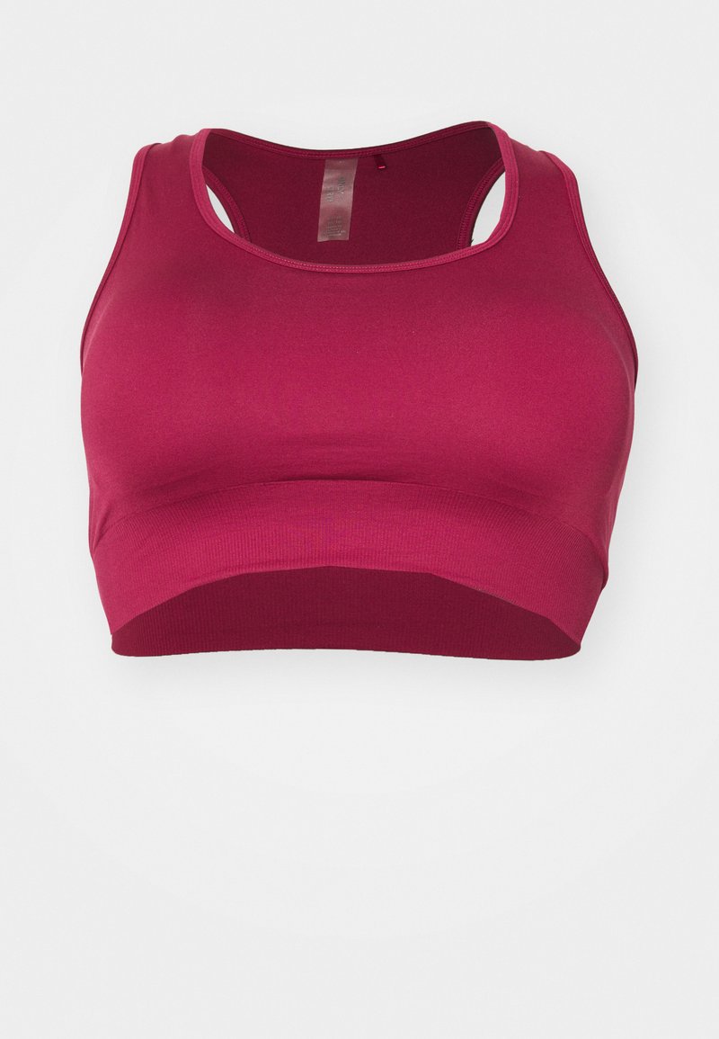 Sujetador deportivo ajustado en rosa oscuro, hecho de material elástico con una textura suave, que presenta un diseño de espalda de nadador y un dobladillo ancho.