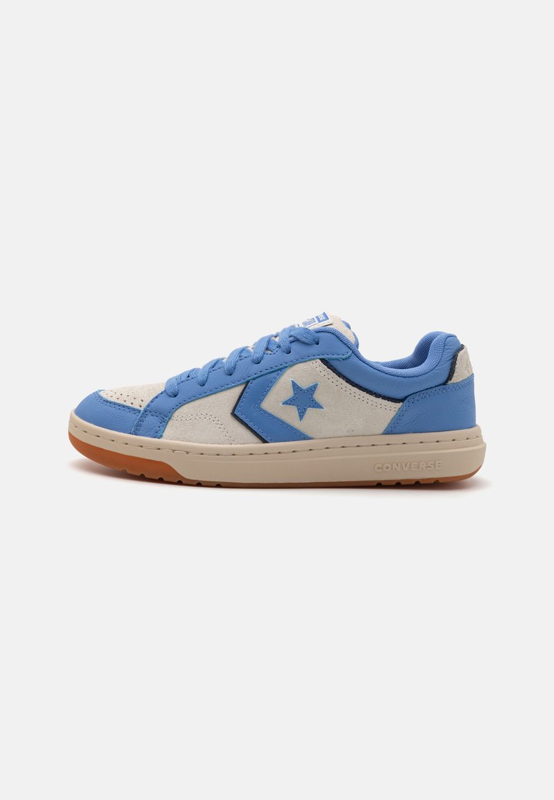 Blue and beige sneaker with suede and leather materials. Features a star logo, round toe, padded collar, and rubber outsole.