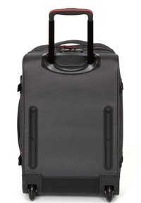 Black wheeled suitcase with a textured exterior, retractable handle, and black plastic accents. Rounded corners and protective wheels.