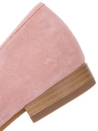 Pink suede shoe heel with brown stacked sole and rubber bottom shown in close-up against white background.