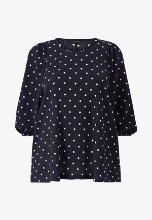 Toppı tummansinisestä kankaasta, jossa on valkoisia pilkkuja, pyöreä kaula-aukko ja puffihihat. Valmistettu teksturoidusta kankaasta. Rentoa istuvuutta.