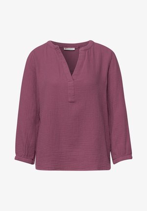 Blouse à manches longues de couleur prune avec tissu texturé, fente en V, col rond et manches avec poignets.
