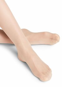 Collants beiges transparents avec une texture lisse, couvrant les pieds et les jambes, dotés d'une zone de orteil renforcée et d'un design minimaliste, offrant un aspect discret.