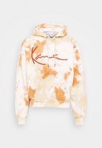 Tie-dye hoodie i krämvit och mjuk orange. Har en framficka, snörning i huvan och broderad logotyp i kontrasterande röd.