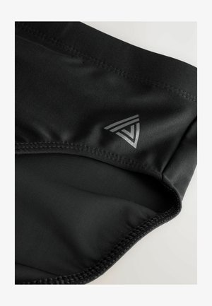Shorts de bain noirs en tissu lisse avec une taille élastique. Présente un petit logo gris avec des accents triangulaires sur le côté gauche.