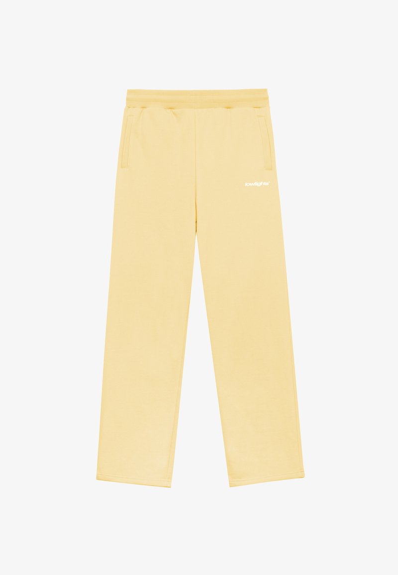Pantalon de survêtement en coton jaune avec une coupe décontractée, présentant des poches latérales et un petit logo blanc sur la jambe gauche. Texture lisse et design simple.