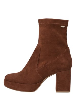 Bottines en daim marron avec un talon bloc, présentant un dessus lisse, un bout arrondi et un détail découpé sur le côté.