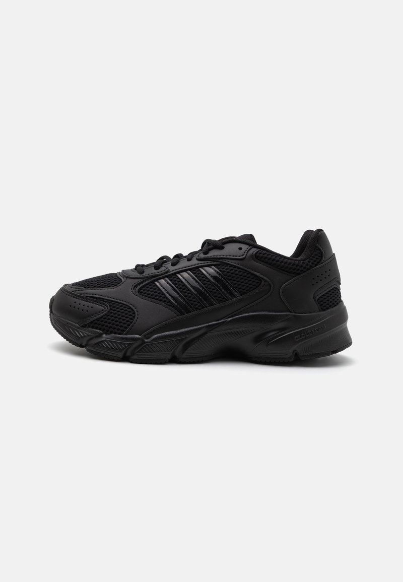 Black athletic shoes featuring a combination of breathable mesh and synthetic materials. Distinct textured sole and three black stripes on the side.