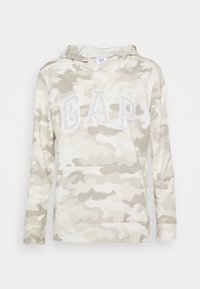 Felpa beige a camouflage con tasca a marsupio e logo "GAP" ricamato in bianco. Tessuto morbido e maniche lunghe. Cappuccio con cordino regolabile.