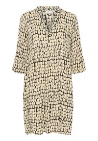 Zwart-witte jurk met een V-hals, korte uitgezette mouwen, een geraffineerde taille en een losse pasvorm, voorzien van een abstract patroon met stippen.