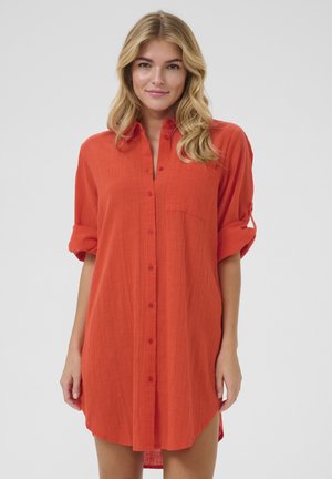 Rotes Hemdkleid aus leichtem Stoff, mit durchgehender Knopfleiste, gerollten Ärmeln und einer Brusttasche, mit einem leicht abgerundeten Saum.