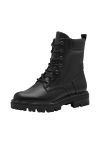 Bottines en cuir noir avec un bout rond, un laçage à l'avant et une semelle à crampons robuste. Présentent des coutures discrètes et une languette à l'arrière.