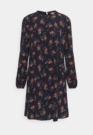 Robe bleu marine à manches longues avec des bouquets floraux rouges, jaunes et blancs, col rond avec léger volant et coupe trapèze décontractée.