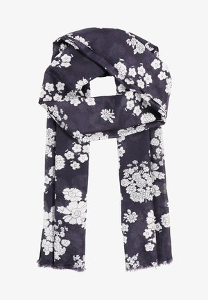 Écharpe bleu foncé avec motif floral blanc, tissu doux et bords effilochés, pliée lâchement.