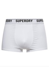 Boxers blancos con el logo negro de "SUPERDRY" en la cinturilla elástica. Textura suave, diseño ajustado y panel frontal sin costuras.