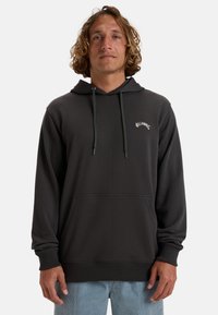 Dark gray hoodie with a front pocket, adjustable drawstrings, and white embroidered "Billabong" logo on the chest. Soft, smooth texture.
