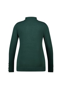 Groene gebreide trui met een hoge hals en lange mouwen. Heeft knoopaccenten bij de manchetten en een gladde textuur.