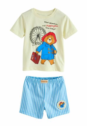 Zweiteiliger Kinderoutfit mit einem cremefarbenen Paddington-Bär T-Shirt und blauen gestreiften Shorts mit einem Paddington-Aufnäher.