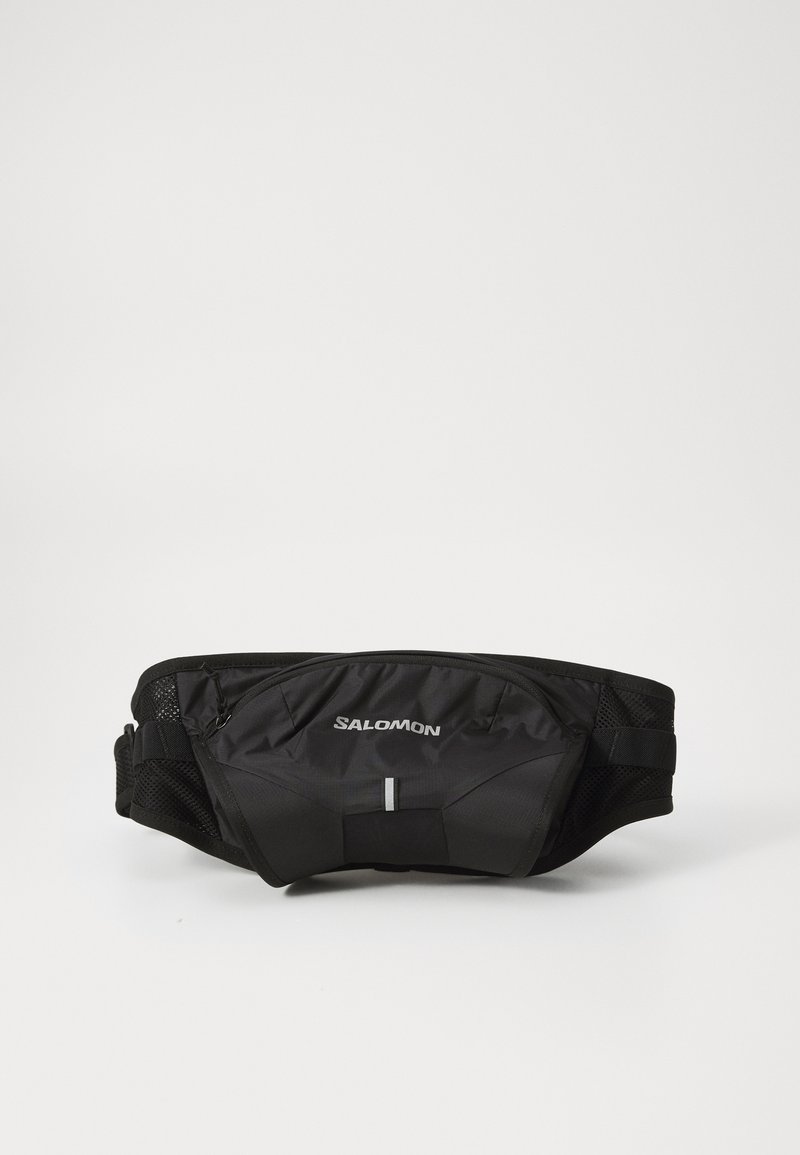 Ceinture de course noire en tissu léger. Comprend une poche zippée à l'avant et des côtés en mesh pour une respirabilité optimale. Accents réfléchissants inclus.