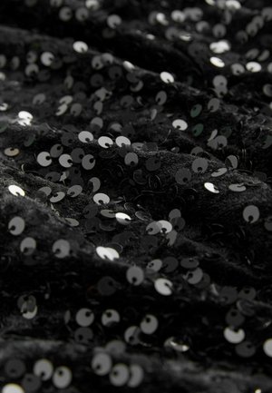 Black fabric covered in shiny, circular sequins. The texture appears soft, with a smooth sheen and a wavy drape.