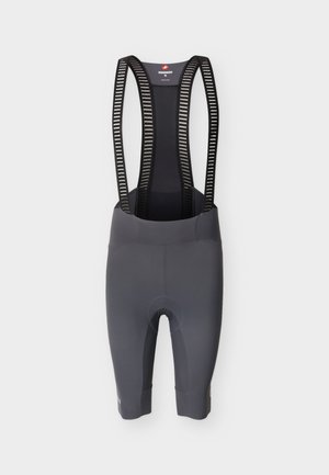 Cuissard de cyclisme gris avec bretelles en mesh noir ornées de rayures blanches horizontales, conçu pour un usage sportif.