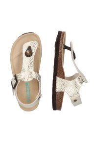 Witte sandalen met een gestructureerde bovenkant, verstelbare gesp en een bruine, gevoerde zool. Heeft een cirkelvormige accent bij de teen.