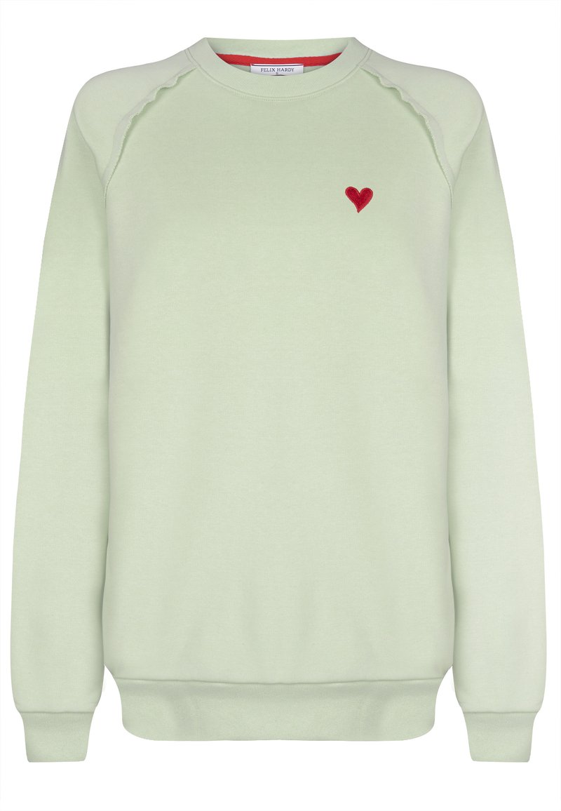 Ljusgrön sweatshirt med ribbad krage och muddar. Har en liten broderad röd hjärta på vänster bröst. Slät textur.