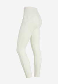 Leggings bianchi con vita alta e texture liscia, caratterizzati da un design senza cuciture e una silhouette aderente, ideali per l'abbigliamento sportivo.