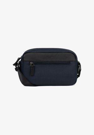 Petit sac bandoulière bleu marine avec panneau supérieur noir et poche avant zippée, sangle noire réglable et tirettes de fermeture éclair en métal.