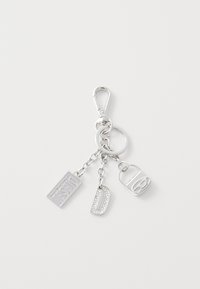 Silver keychain with clips, featuring three charms: a rectangular tag engraved "Diesel," a metallic letter "D," and a small lock shape.