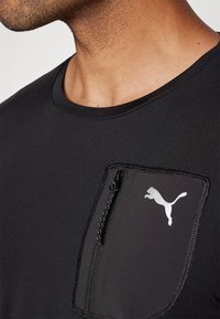Puma FLEX TEE - Sports T-shirts - black
