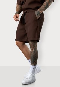 ESTEEM PLEATED - Tracksuit bottoms - coffee