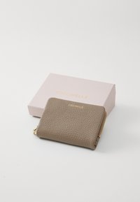 Brown textured leather wallet with gold zipper and logo, placed beside a pink packaging box featuring gold branding.