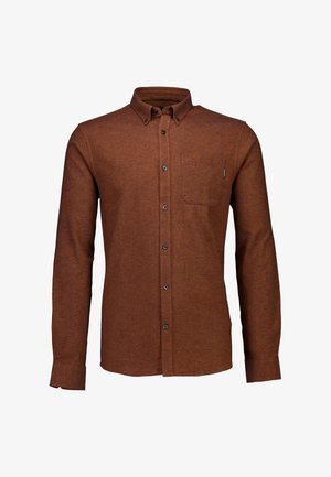 Ruskea napitettu paita, joka on valmistettu teksturoidusta kankaasta. Sisältää rintataskun ja mustat napit. Pitkät hihat, joissa on nappikiinnityksellä varustetut hihansuut.