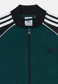 adidas Originals TRACK UNISEX - Majica s kapuljačom i patentnim zatvaračem - aurora ivy