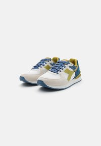 Sneakers featuring a white mesh upper, light gray suede accents, blue laces, and a green heel and side panel. Rubber sole with textured tread.