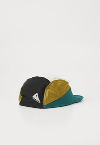 Multicolored cap featuring black, yellow, white, and teal panels. Made of soft fabric with a curved visor and a logo on the side.